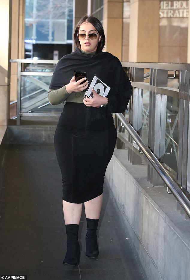 Stolen funds were deposited into newly opened bank accounts and debit cards were sent to false addresses in Hong Kong, where $2.5 million was laundered. Pictured is Vella-Arpaci walking to the court