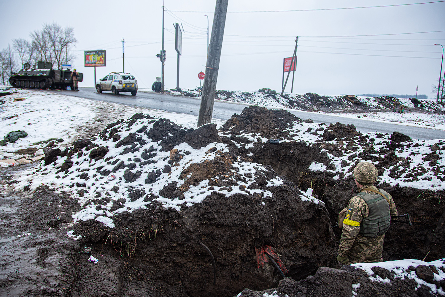 A Ukrainian soldier looks out from a trench on the outskirts of Kharkiv.