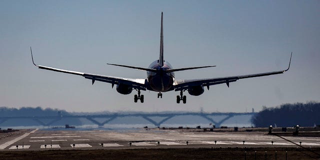 A Southwest plane lands at Ronald Reagan Washington National Airport in Arlington, Va., Friday, Dec. 30, 2022. A computer outage at the Federal Aviation Administration brought flights to a standstill across the U.S. on Wednesday, with hundreds of delays quickly cascading through the system at airports nationwide.  