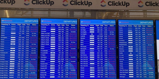 A message board shows departures at Ronald Reagan Washington National Airport in Arlington, Va., on Wednesday, Jan. 11. 2023. 
