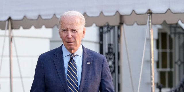 President Biden walks over to talk with reporters before he and first lady Jill Biden board Marine One on the South Lawn of the White House in Washington, Wednesday, Jan. 11, 2023. 